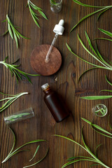 Alternative medicine, medicinal herbs for essences and tablets. Green leaves and a glass bottle for essential oils.