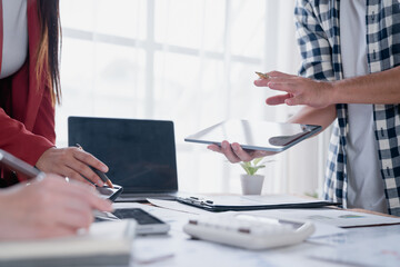 Business colleagues collaborating on digital tablet in meeting