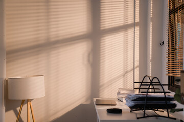 Morning sunlight creating shadow patterns in home office interior