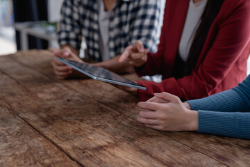 Business team collaborating on digital tablet for strategy