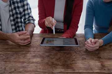Business team analyzing data on digital tablet during meeting