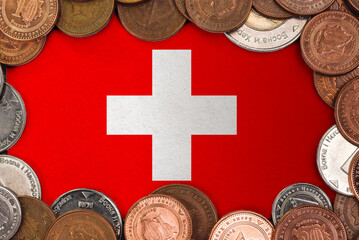 Coins on flag of Switzerland trading investment business currency concept
