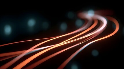 Abstract streaks of luminous light in orange and blue flow smoothly against a dark blurred background with bokeh