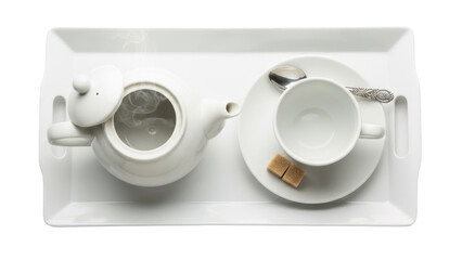 Close up overhead of a tray with a teapot, cup, and saucer arranged for afternoon tea isolated on white background