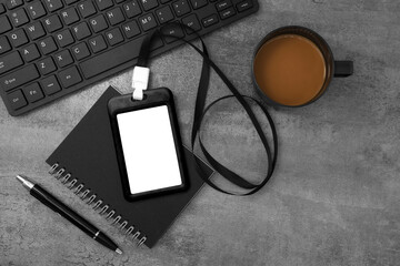 Black plastic badge with keyboard and coffee on stone texture background. Template designed for employees of company