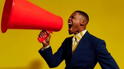 Excited businessman in blue suit shouts into giant red megaphone on yellow background symbolizing announcement leadership motivation and bold marketing communication message