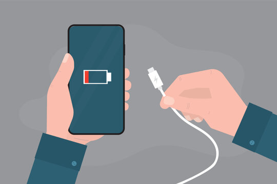 Hands holding mobile phone and charger. Low battery sign on cellphone screen, white cable, technologies of gadget charging. Wire with plug