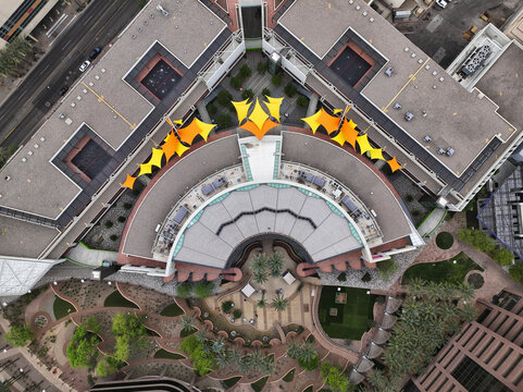 Aerial view of the curving lines of buildings and garden spaces create a harmonious blend of form and nature, punctuated by bright yellow awnings, Phoenix, Arizona, United States.