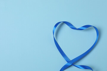 Curled blue ribbon on a colored background
