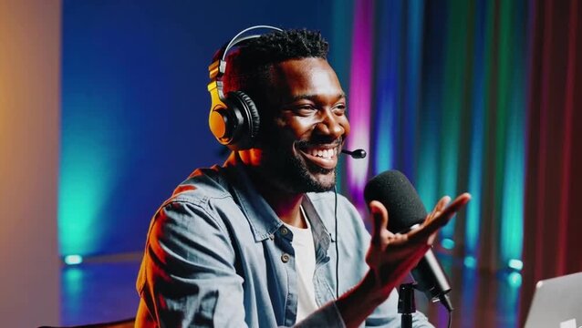 Smiling man wearing headphones speaking into microphone, podcasting, streaming and modern digital communication concept.