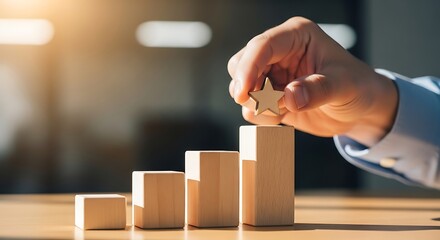 Hand Placing Wooden Block on Stacked Blocks Symbolizing Growth.