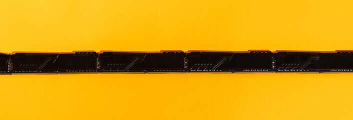 Macro of RAM gold contacts on bright yellow background. High quality photo