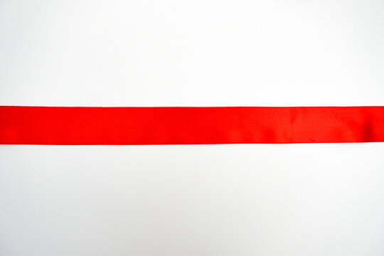 Red satin ribbon isolated on white background. Gift box decor, Christmas design element, wrap decoration