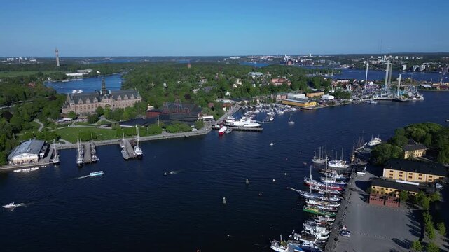 Aerial view of the Vasa Museum and Grona Lund amusement park on a sunny day, with boats docked along the waterfront, Stockholm, Stockholm County, Sweden.
