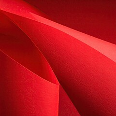Abstract close-up of folded red paper with curving lines and textures