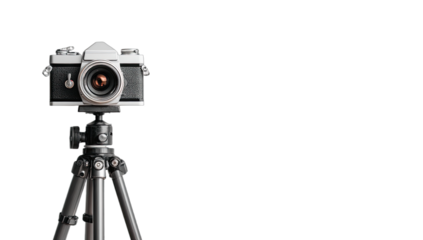 Vintage camera on a tripod against a black backdrop, studio shot