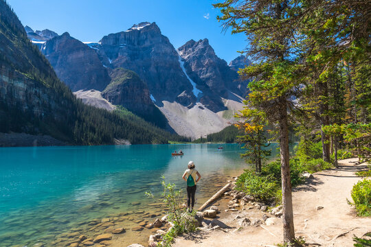Tourist admiring moraine lake in banff national park, canadian rockies
