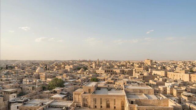 Panoramic view of Middle Eastern city with ancient architecture and birds flying in formation above homes