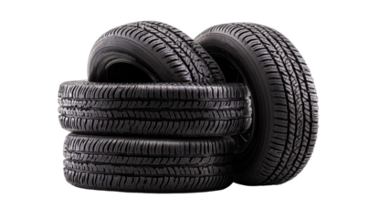 Stack of four black rubber tires on a black background, studio shot