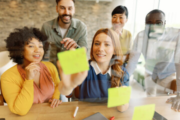 Team collaborating in an office using sticky notes for planning and strategy