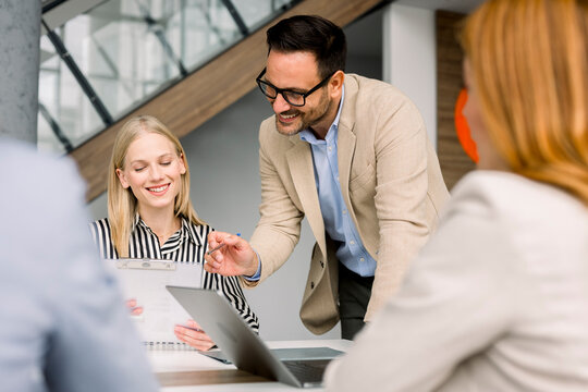 Business team explaining chart during meeting in modern office