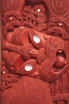 Traditional Maori wood carving outside meeting house in Rotorua New Zealand