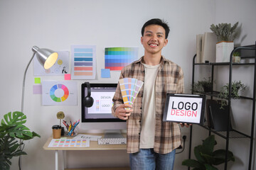 Young Professional With Tablet in Hand Showing His Approval of Digital Logo Concept on Bright Screen