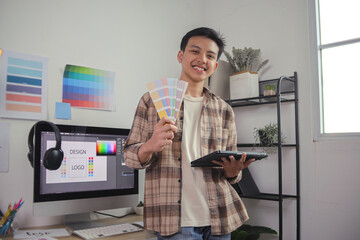 Smiling male designer holds color Swatches and Tablet, Ready for Logo Branding and Creative Work