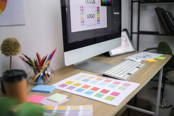 Modern Graphic Design Workspace With Computer Showing Logo Concept Color