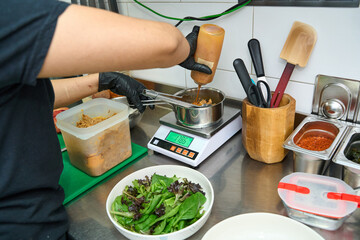 Professional food preparation with fresh salad ingredients in kitchen