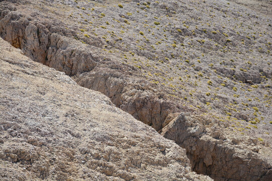 Rupture (Uvala Rupa) viewed from above near Baska on island Krk shows a deep dramatic geological crack in the barren limestone landscape