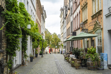 Koblenz, Germany - 16 September 2025: View of a quaint cobblestone street lined with vibrant buildings and lush greenery, inviting a peaceful stroll through history.