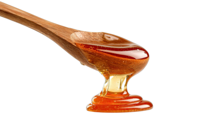 Golden liquid drips from a wooden spoon, creating viscous layers on a dark background