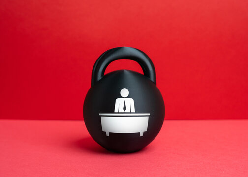 A weight with an image of a bureaucrat. A concept of the burden of bureaucracy and an overly bloated administrative staff. Excessive regulation, institutional pressure, inefficient governance.