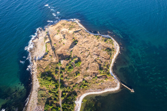 Aerial view of the rugged coastline meets the vast, deep-blue sea at Cape Cherni Nos, a serene contrast of earth and water, Nos Chervenka, Chernomorets, Bulgaria.