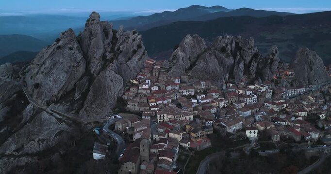 Aerial view of Pietrapertosa, a village nestled in the Dolomiti Lucane mountains, featuring a blend of stone buildings and rocky peaks, Pietrapertosa, Basilicata, Italy.