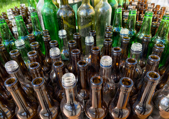 stack of empty glass bottles collected for recycling