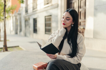 Person enjoying a peaceful moment reading a book outdoors in Madrid