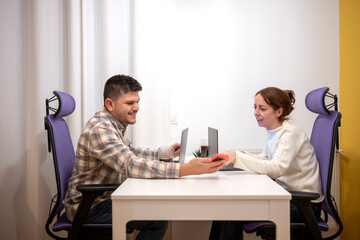 Couple collaborating working from home office on laptops