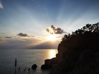 Sunset over the sea with reeds in foreground. Peaceful nature beauty. Relaxing athmosphere