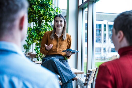 Woman leading coworking business meeting in modern office