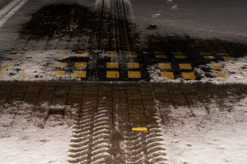 Traffic management. An artificial obstacle in front of a pedestrian crossing under snow.