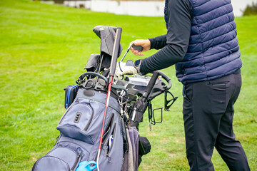 Golfer takes out the stick from his bag
