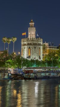 Torre del Oro timelapse hyperlapse, a dodecagonal military watchtower in Seville, Spain. Built by the Almohads to control Guadalquivir River access. Historic landmark with reflections at night.