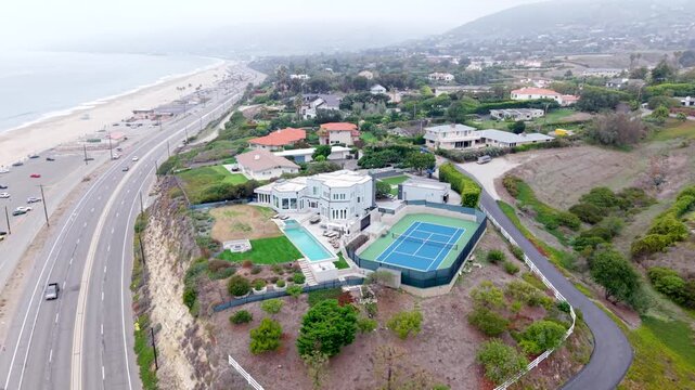 Fog filled wealthy And luxurious Houses Overlooking Zuma Beach Coast At Point Duma In Malibu, California. Rising Aerial.