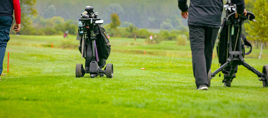 People, golfers enjoying on the golf course, playing together