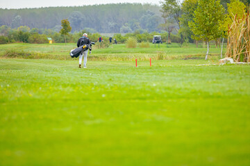 People, golfers enjoying on the golf course, playing together