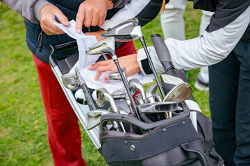 People, golfers enjoying on the golf course, playing together