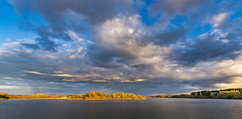 Cloudy sky with a lake in the background