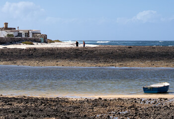 A fishing village with old houses on the Atlantic ocean coast of Fuerteventura island.